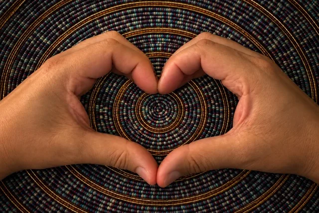 Two hands forming a heart in front of a circular woven mat